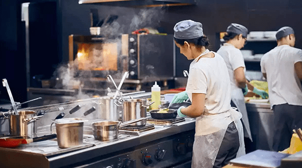 Chefs preparing food in a restaurant kitchen